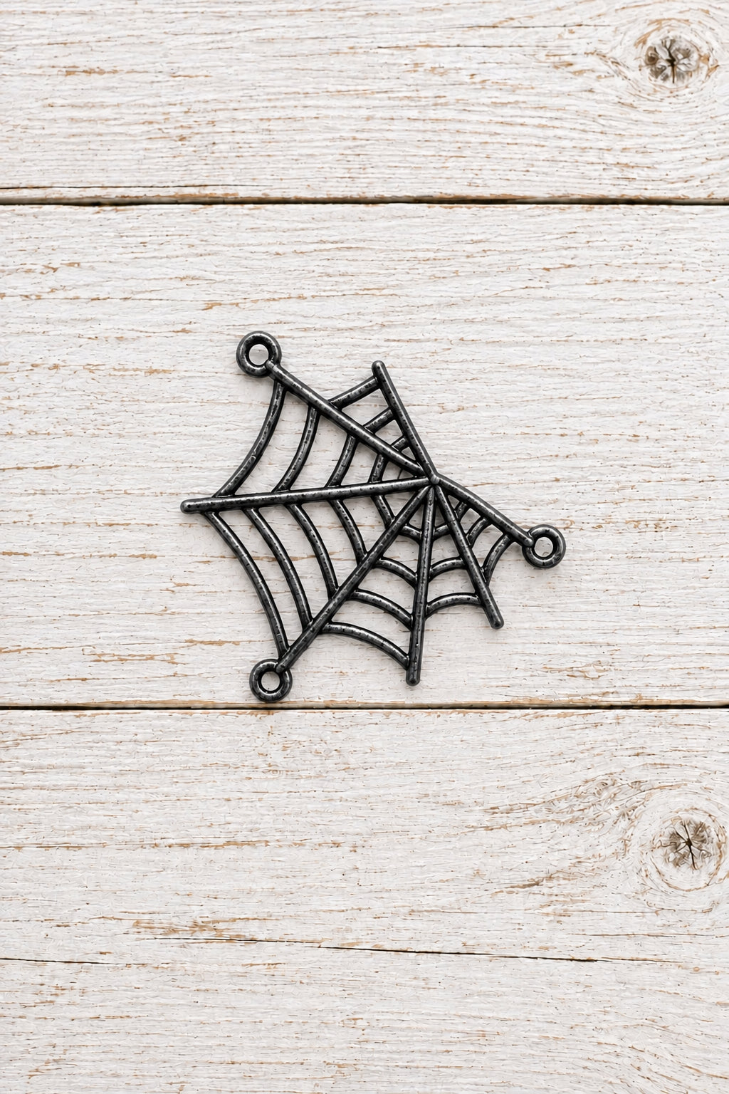 metal spider web connector with three attachment loops for jewellery making.