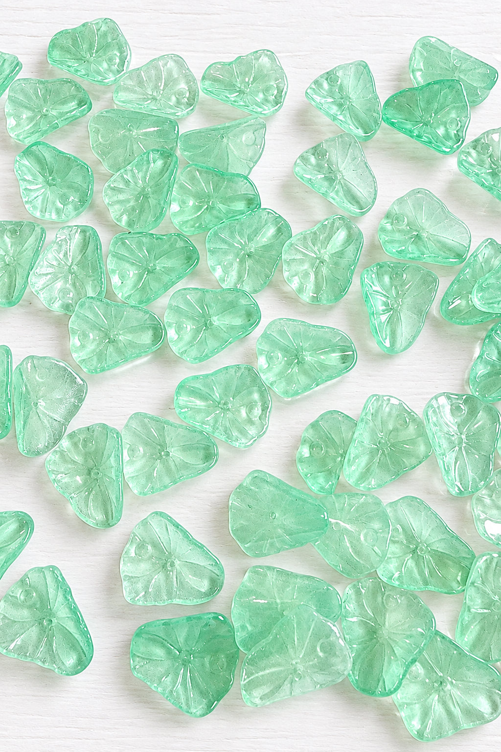 Light green translucent lily pad beads with textured leaf detailing