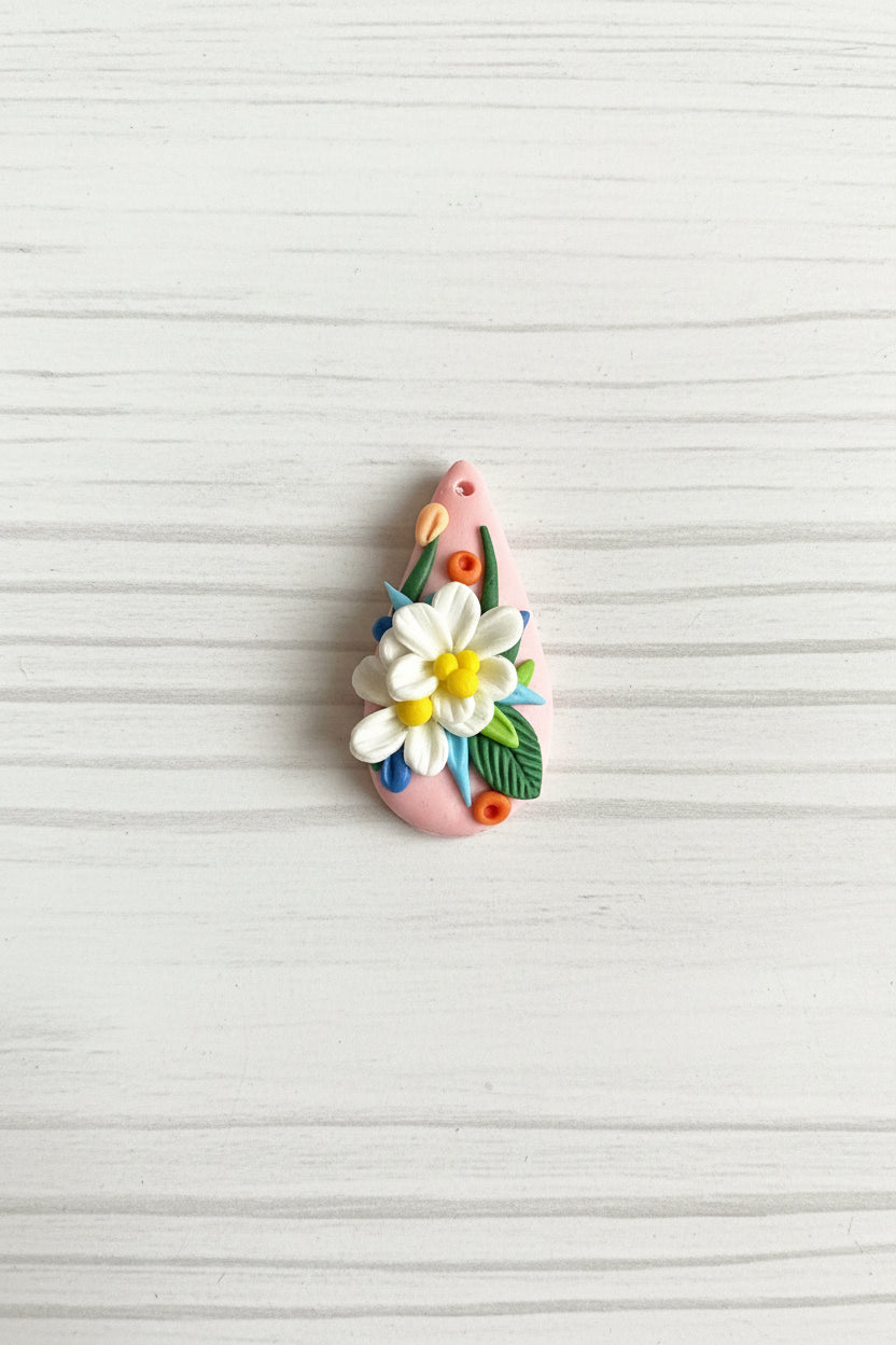 Handmade polymer clay floral pendant, lightweight and handcrafted with intricate 3D flower and leaf details, suitable for necklaces, earrings, and bag charms