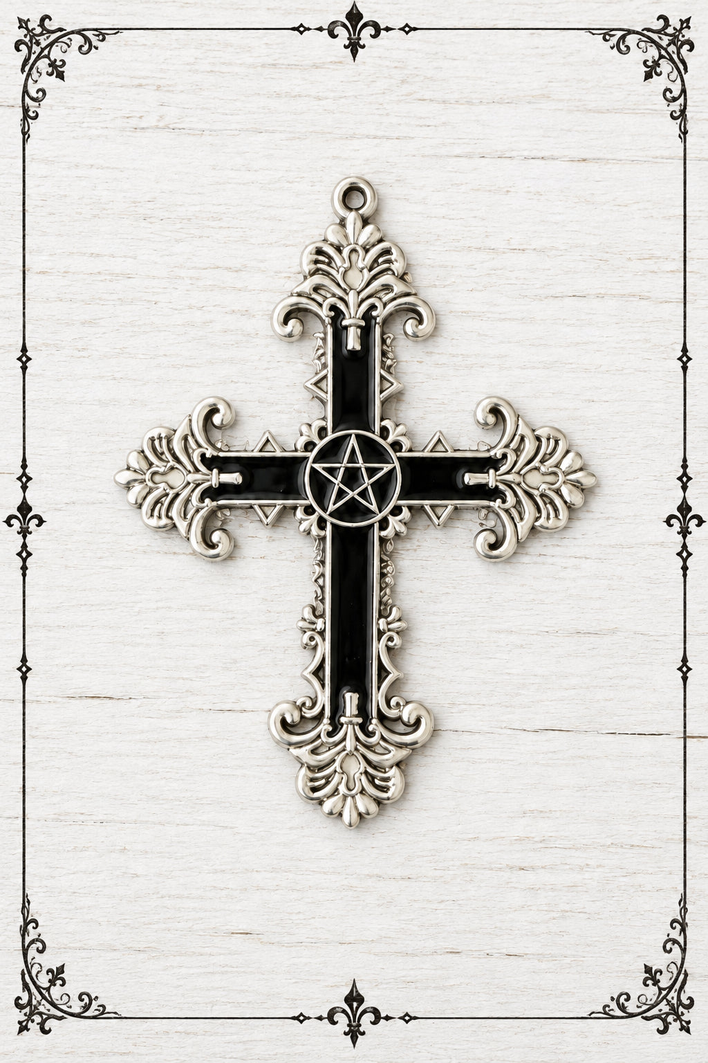 Large gothic cross pendant with black panels, ornate silver-coloured scrollwork and a central pentagram.