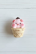 Cute pig figurine balanced on a chocolate macaron craft embellishment - Kingyscrafts