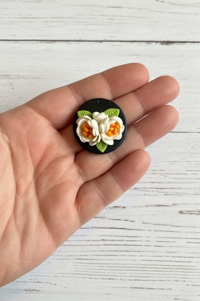 Handmade polymer clay floral pendant, lightweight and handcrafted with intricate 3D flower and leaf details, suitable for necklaces, earrings, and bag charms