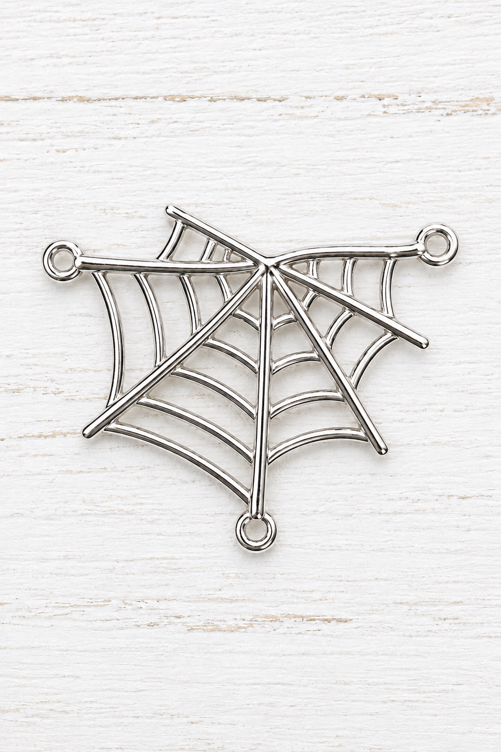 metal spider web connector with three attachment loops for jewellery making.