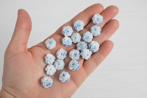 14mm white and blue soft rose flower embellishments held in a hand to show size, pack of 50 for crafts