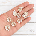 Pack of 25 patterned acrylic leaf beads.