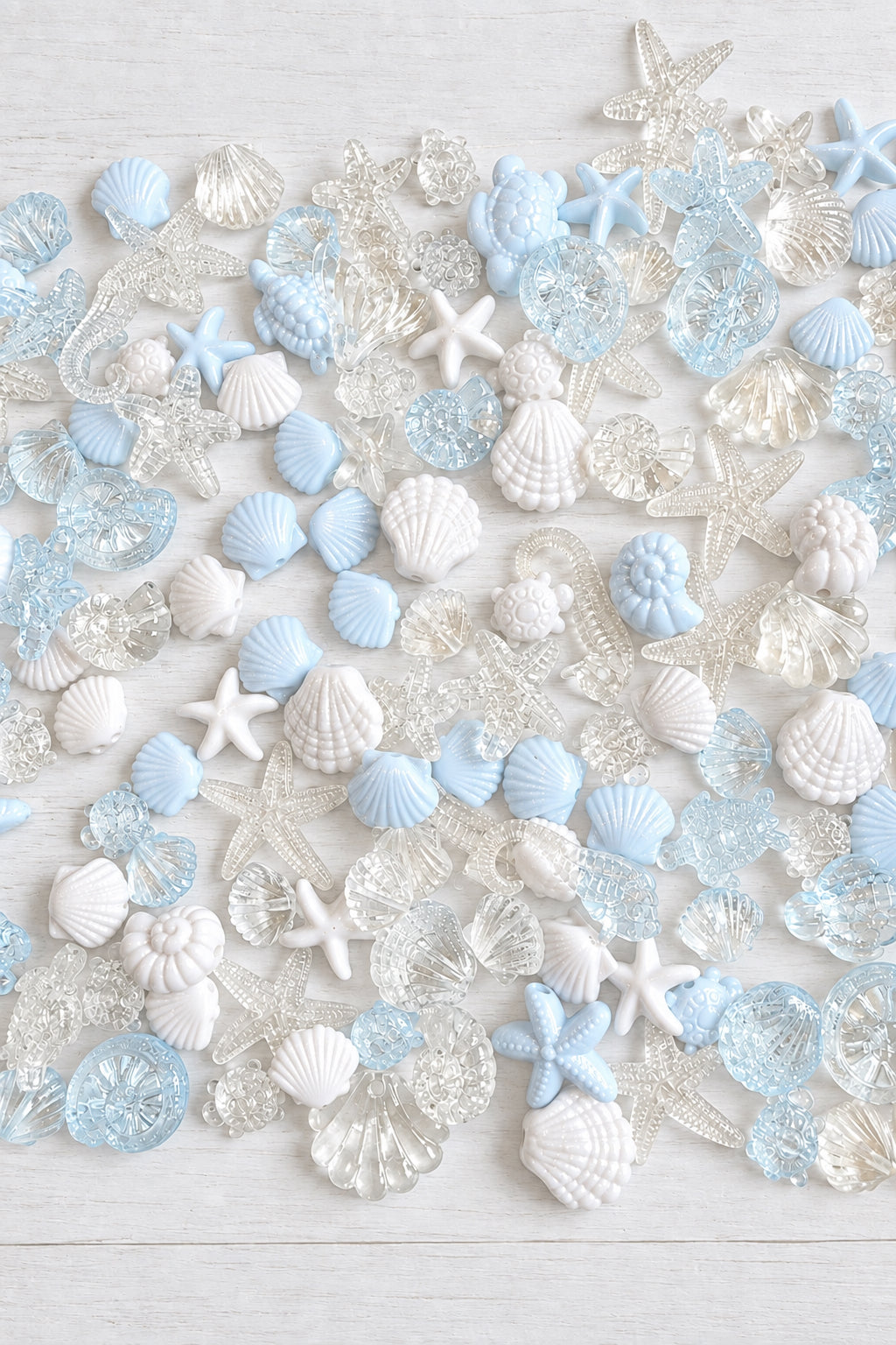 Mixed acrylic sea-themed beads in pale blue, white and clear, including shells, starfish, seahorses and turtles