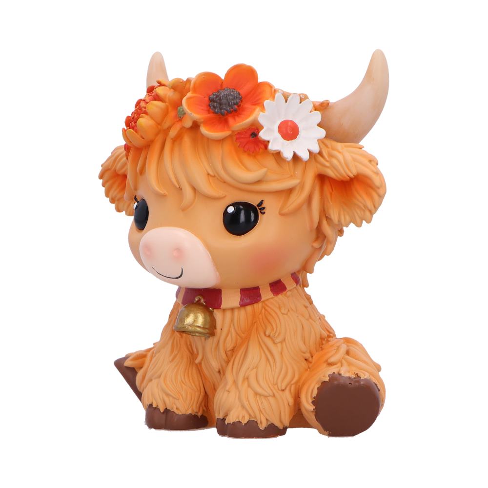 Moo Crew Marigold orange cow figurine with a flower crown and bell collar, displayed among autumn flowers.