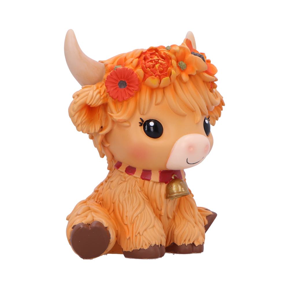 Moo Crew Marigold orange cow figurine with a flower crown and bell collar, displayed among autumn flowers.
