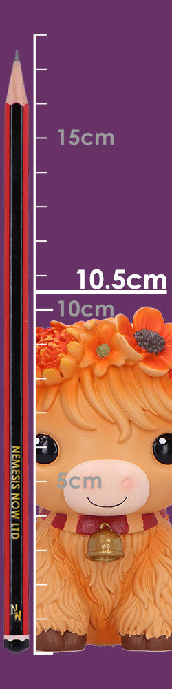 Moo Crew Marigold orange cow figurine with a flower crown and bell collar, displayed among autumn flowers.