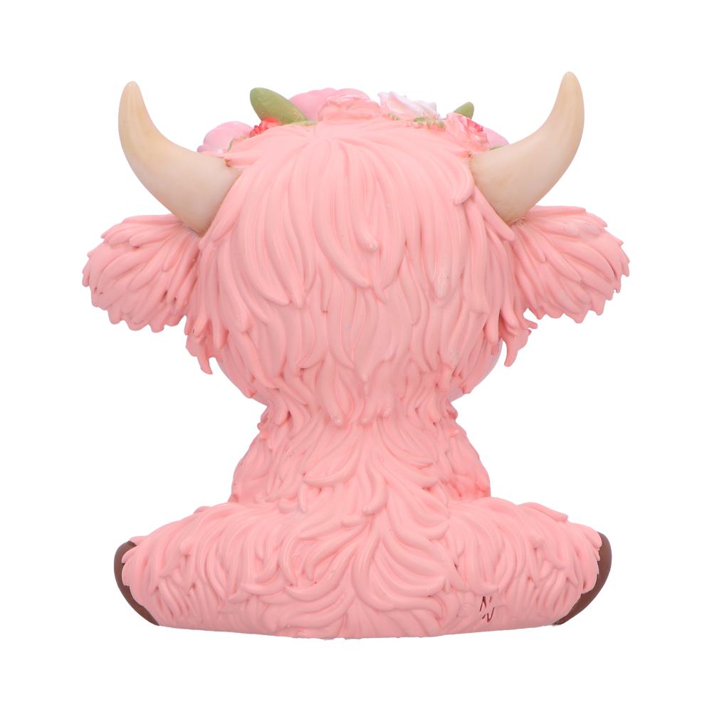 Moo Crew Primrose pink cow figurine with a pink rose crown and gold bell, displayed among pink flowers.