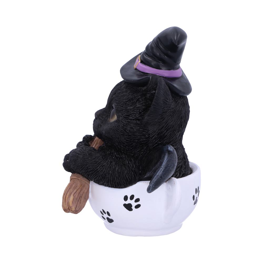 Kit-tea black cat figurine wearing a witch’s hat with bat wings, holding a broomstick in a white paw-print teacup.