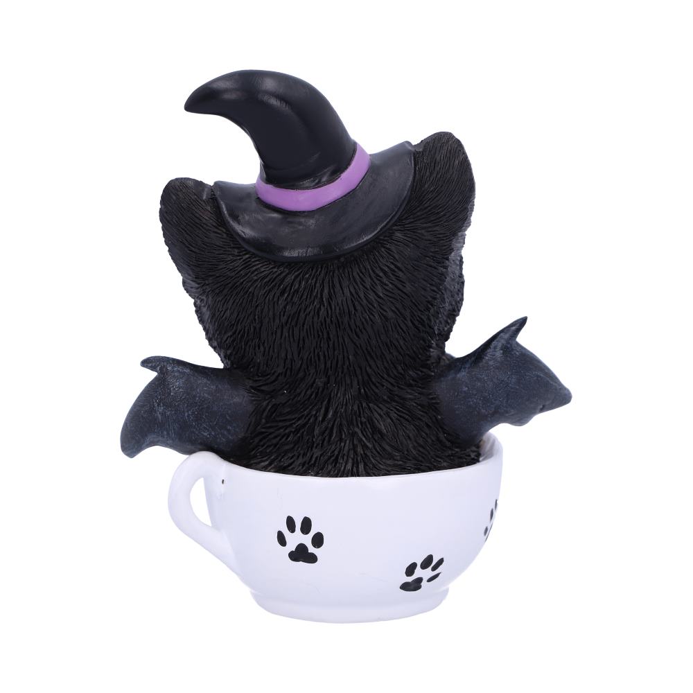 Kit-tea black cat figurine wearing a witch’s hat with bat wings, holding a broomstick in a white paw-print teacup.
