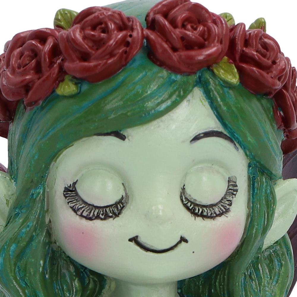Spirit Fairy Elaria figurine with green hair, a red rose crown, closed eyes and dark wings, holding a red rose