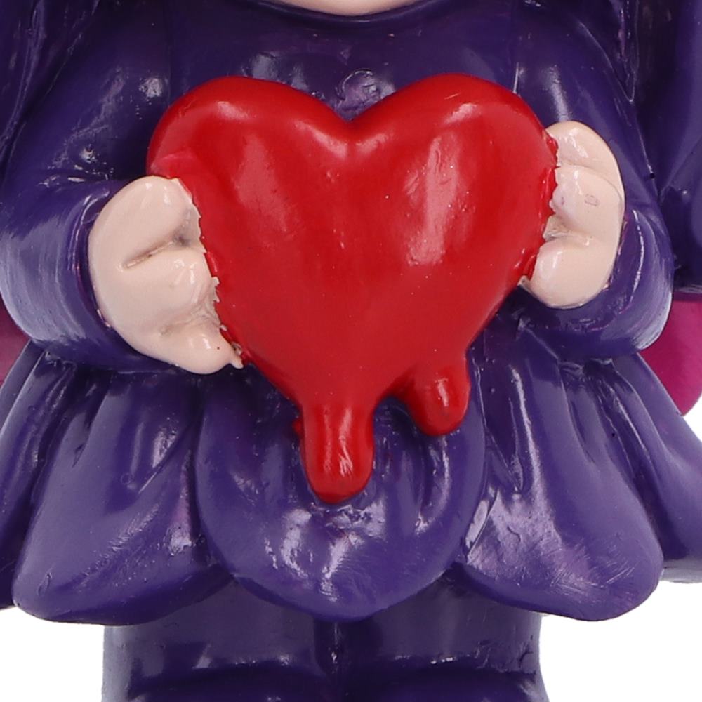 Spirit Fairy Mirella figurine with purple hair and dress, pink wings and large dark eyes, holding a melting red heart