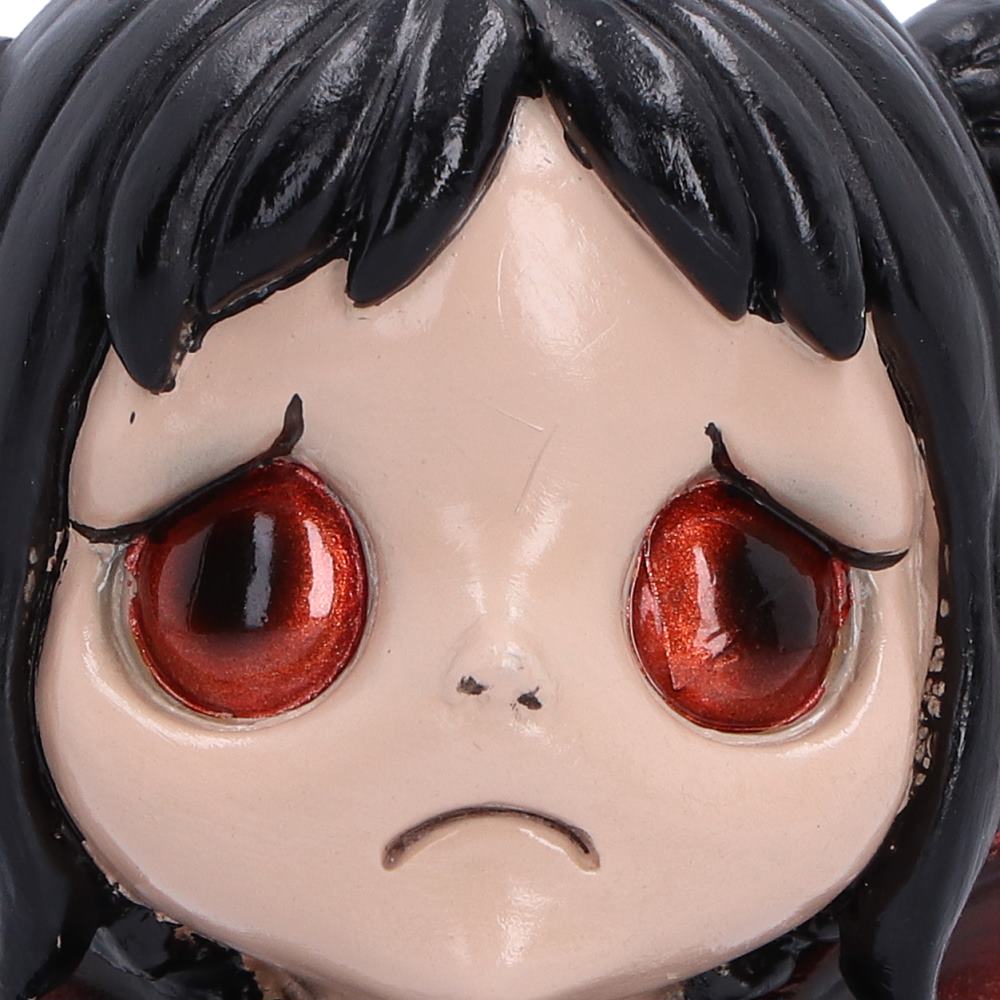Spirit Fairy Mortina figurine with black hair, red eyes and red-accented wings, wearing a black ruffled dress with clasped hands and a frown.