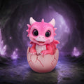 Shellbound pink dragon figurine emerging from a cracked egg.